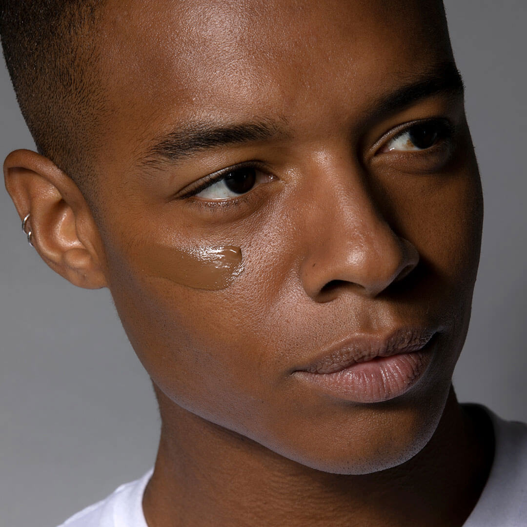 Close-up of a person's face with cosmetic products applied to the skin.