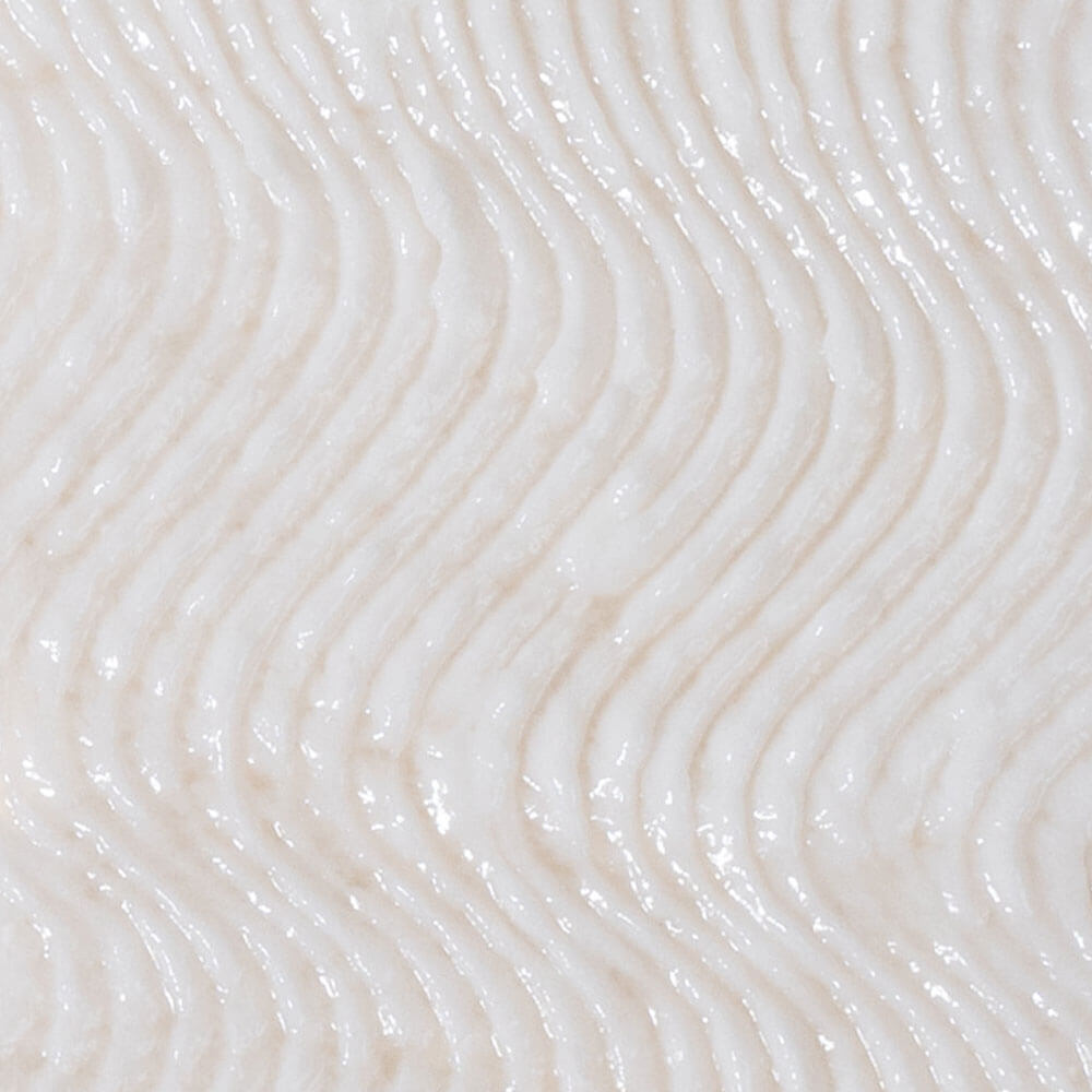 Close-up of a textured white surface with wavy patterns