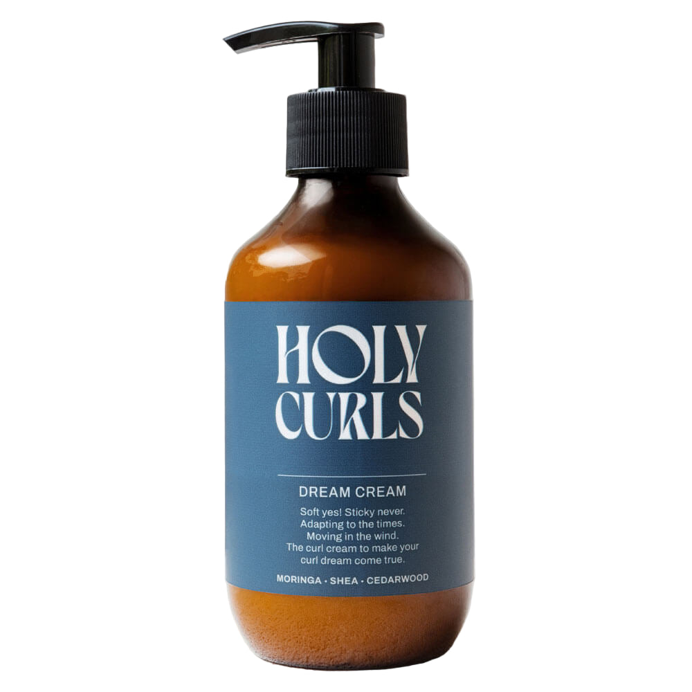 Bottle of Holy Curls Dream Cream with a pump on a light gray background