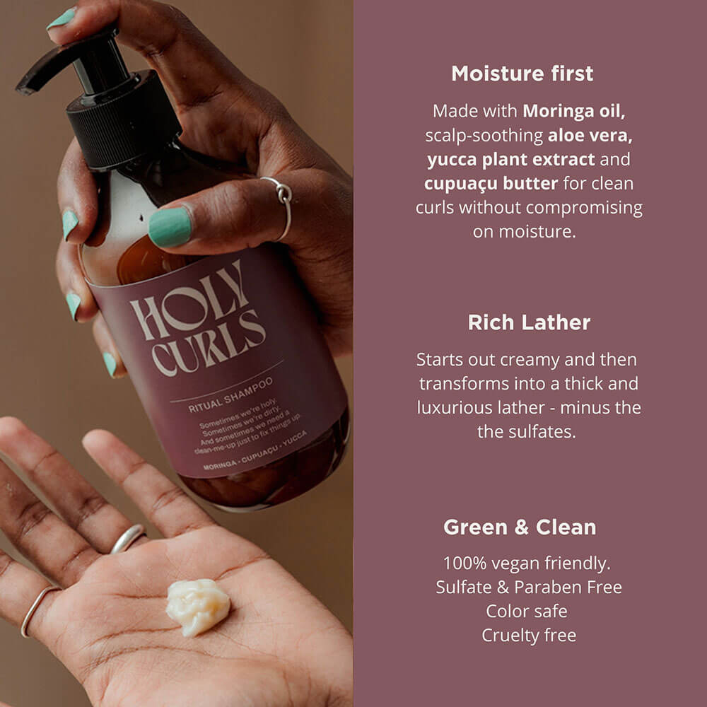 Hand holding a bottle of 'Holy Curls' shampoo with product details on a brown background
