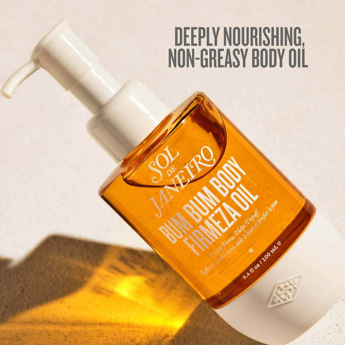 Bottle of Sol de Janeiro Bum Bum Body Firmeza Oil with pump on a beige background