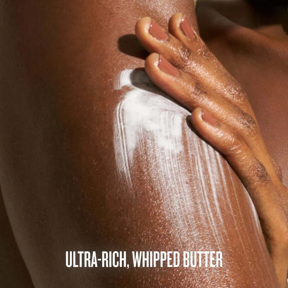 Hand applying ultra-rich whipped butter to skin