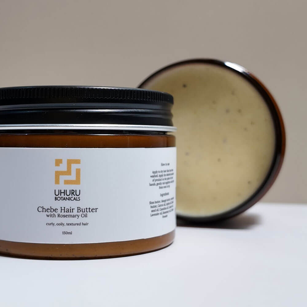 Uhuru Botanicals Chebe Hair Butter jar with open lid on a neutral background
