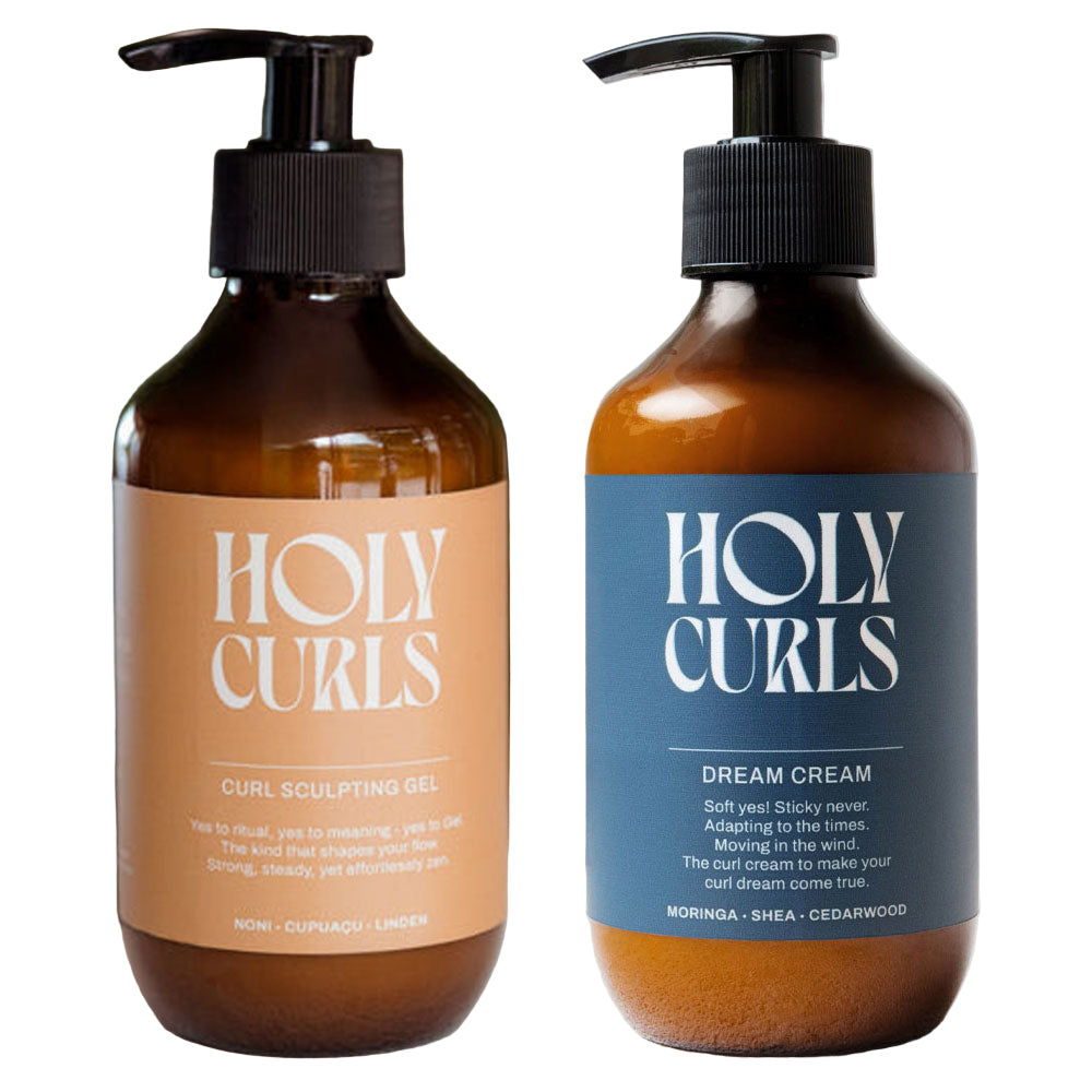 Two bottles of 'Holy Curls' products on a neutral background