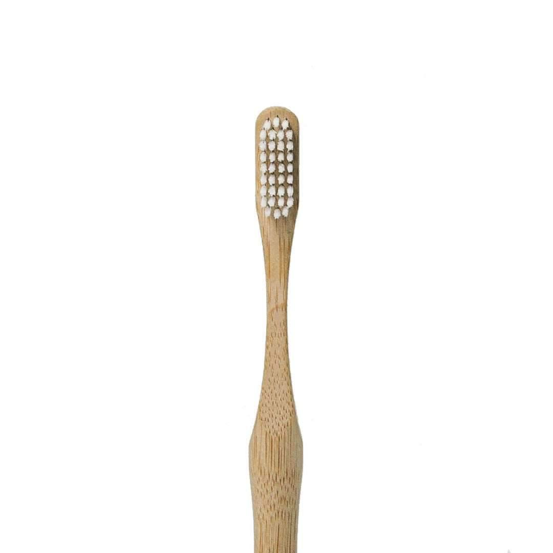 Bamboo toothbrush with wooden handle on a white background