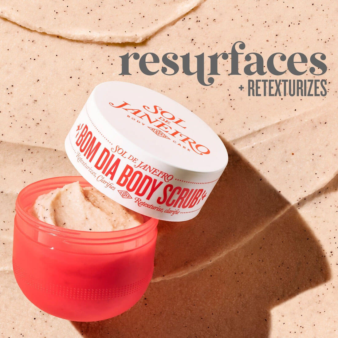 Jar of Sol de Janeiro Bom Dia Body Scrub on a beige background with text overlay.