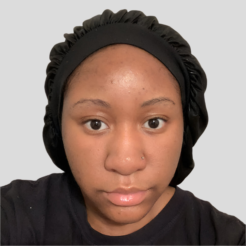 Woman showing skincare results from using Uhuru Botanicals products