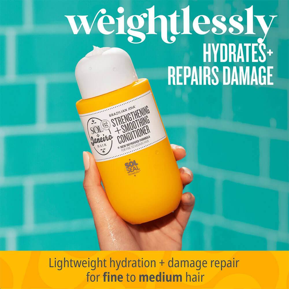 Hand holding a bottle of conditioner with text about hydration and damage repair against a teal tiled background.
