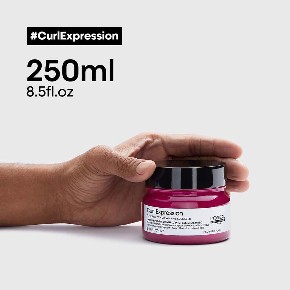 L'Oreal Curl Expression jar held by a hand with product details on a white background