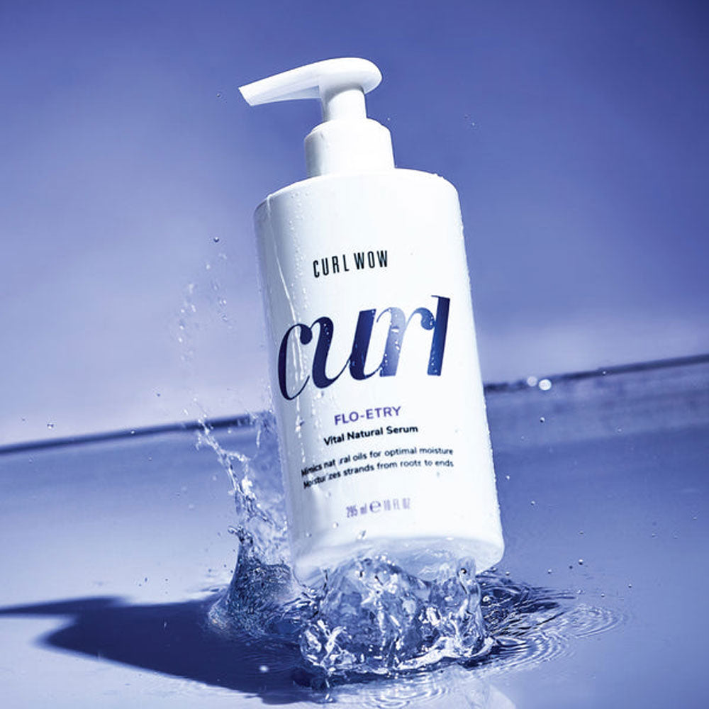 Curl Wow bottle with pump in water on a blue background