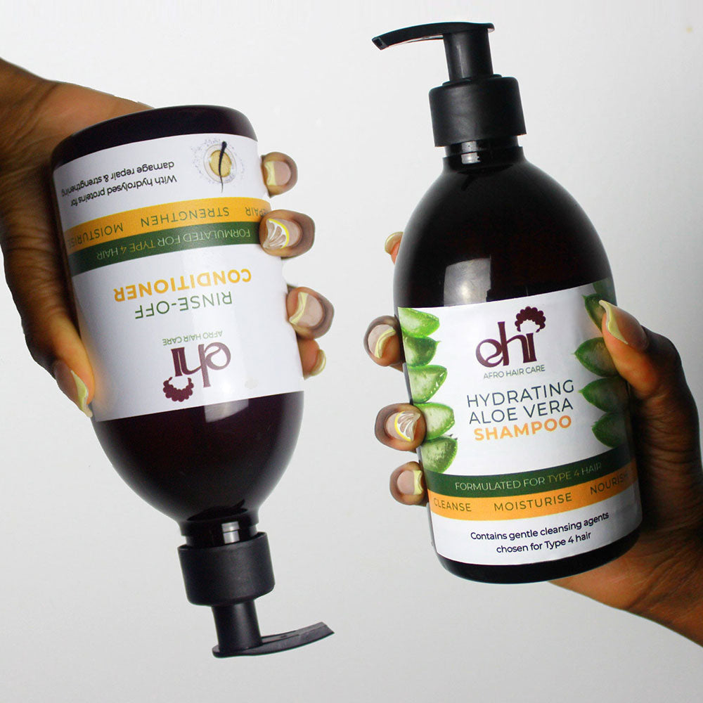 Two bottles of hair care products, one conditioner and one shampoo, held by hands against a white background.