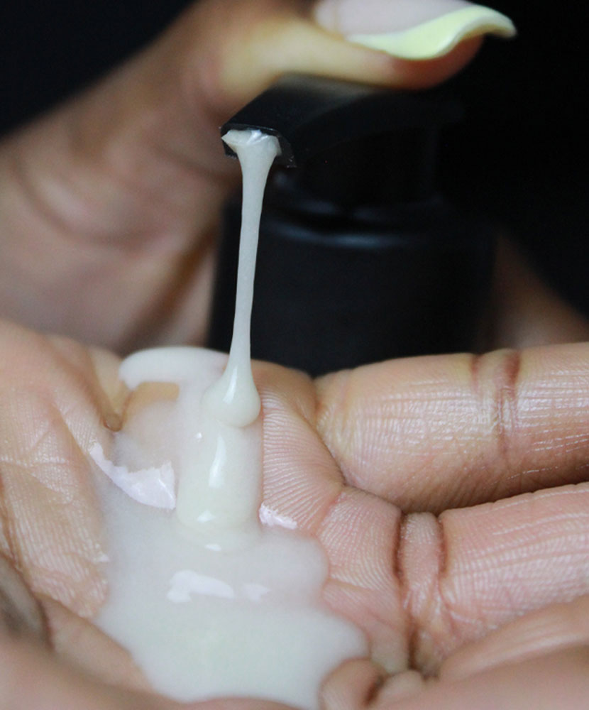 Close-up of a hand holding a white creamy substance with a blurred background