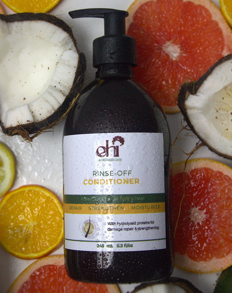 Bottle of Rinse-Off Conditioner with a label on a background of sliced fruits