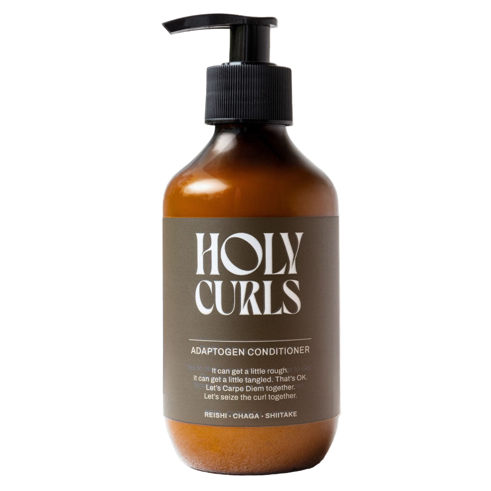 Bottle of Holy Curls conditioner with a pump on a light gray background