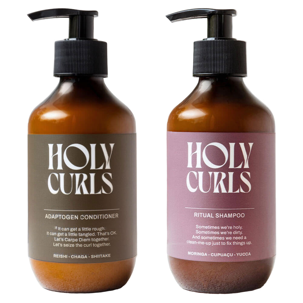 Two bottles of 'Holy Curls' shampoo and conditioner on a light background