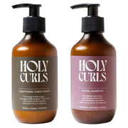 Two bottles of 'Holy Curls' shampoo and conditioner on a light background