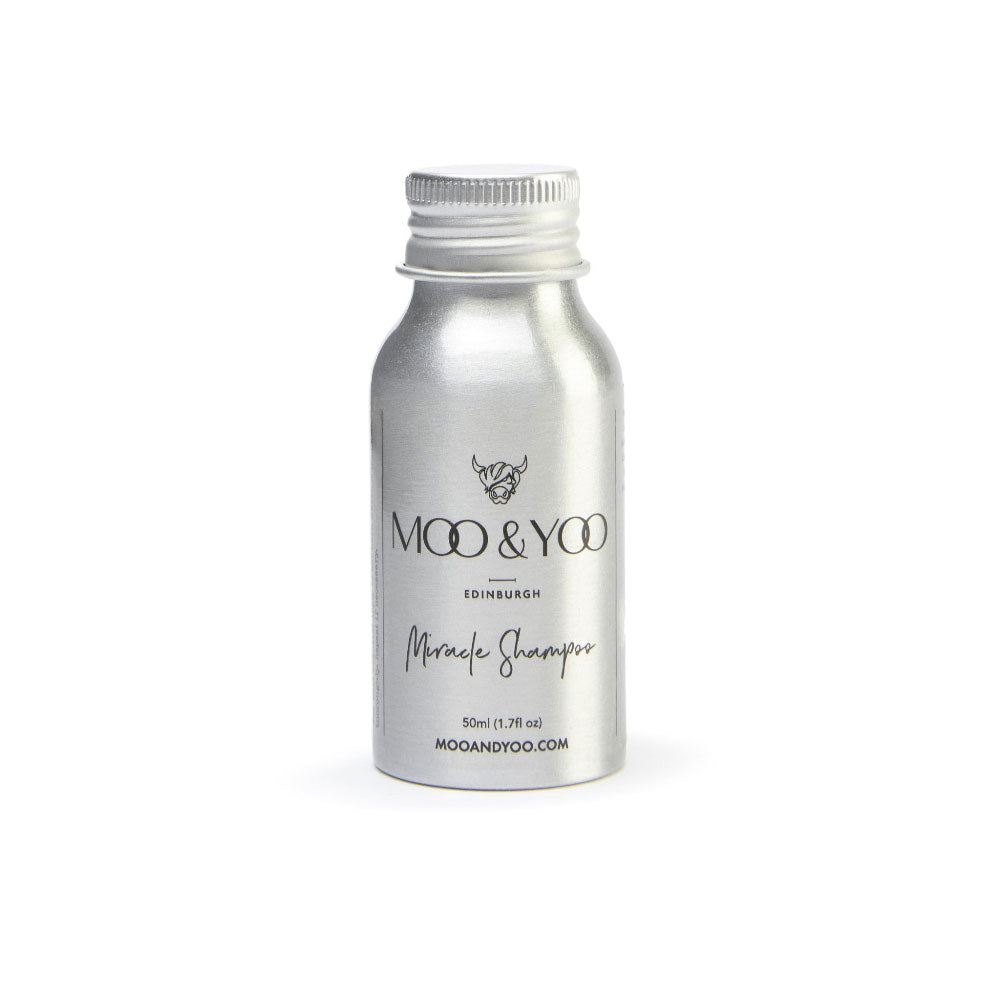 Silver bottle of Moo & Yoo shampoo on a white background