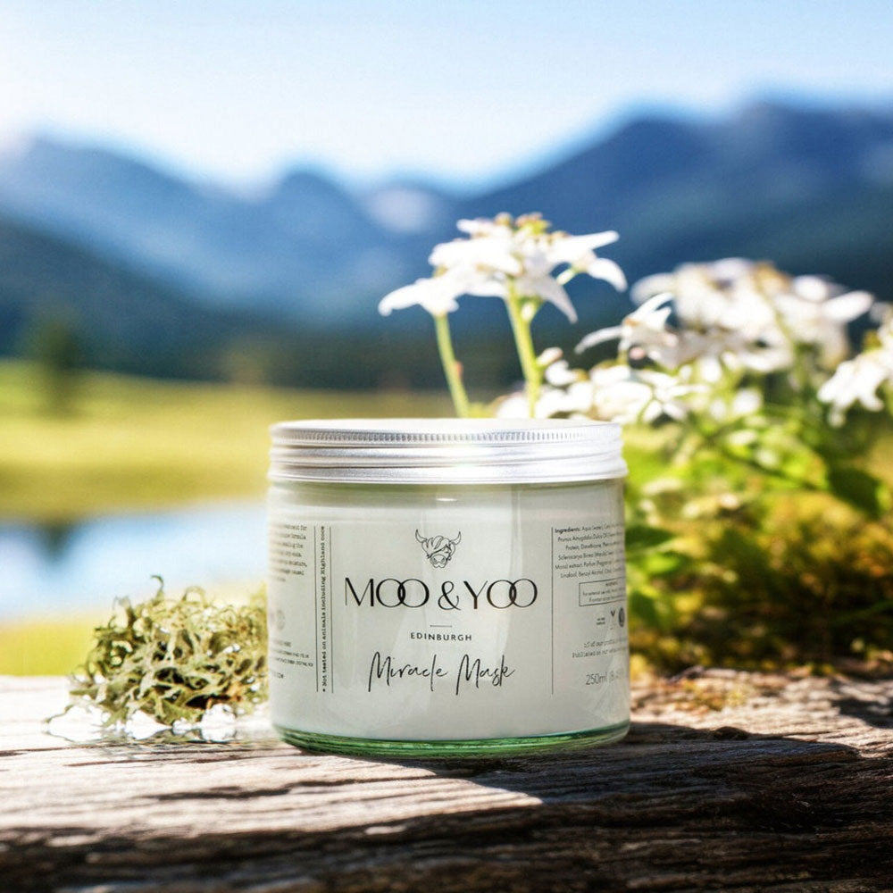 Jar of Moo & Yoo skincare product with a scenic background