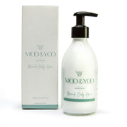 Moo & Yoo body lotion with pump and packaging on a white background