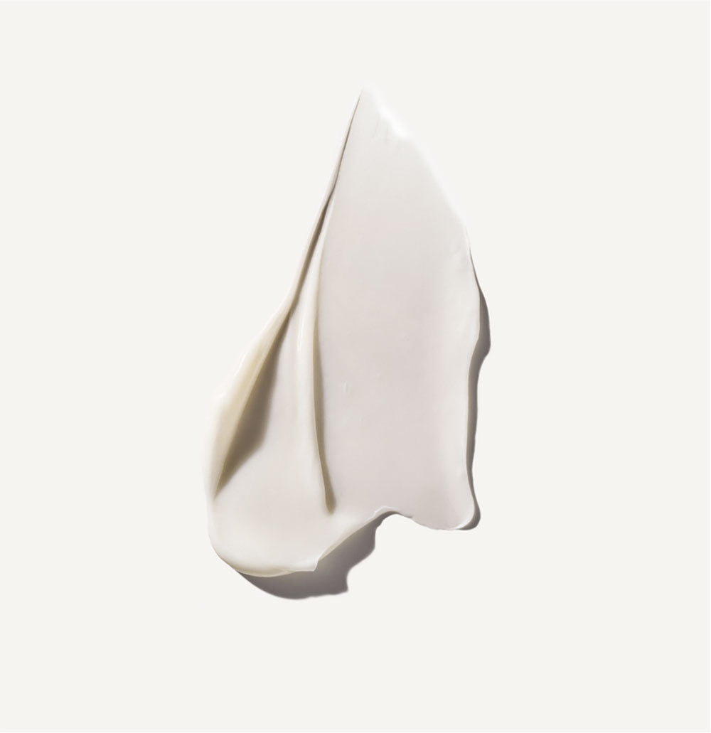 White cream droplet on a light gray background
