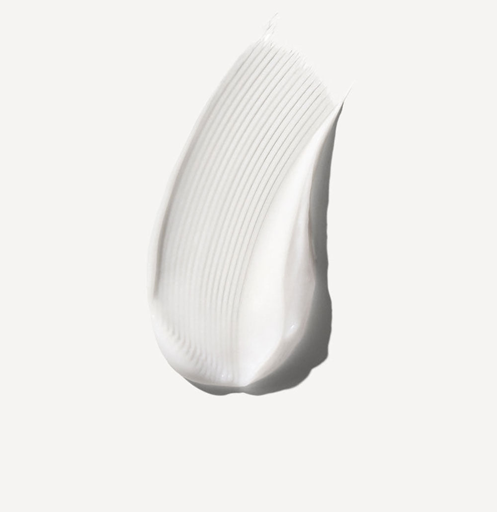 White ceramic vase with ribbed texture on a light gray background