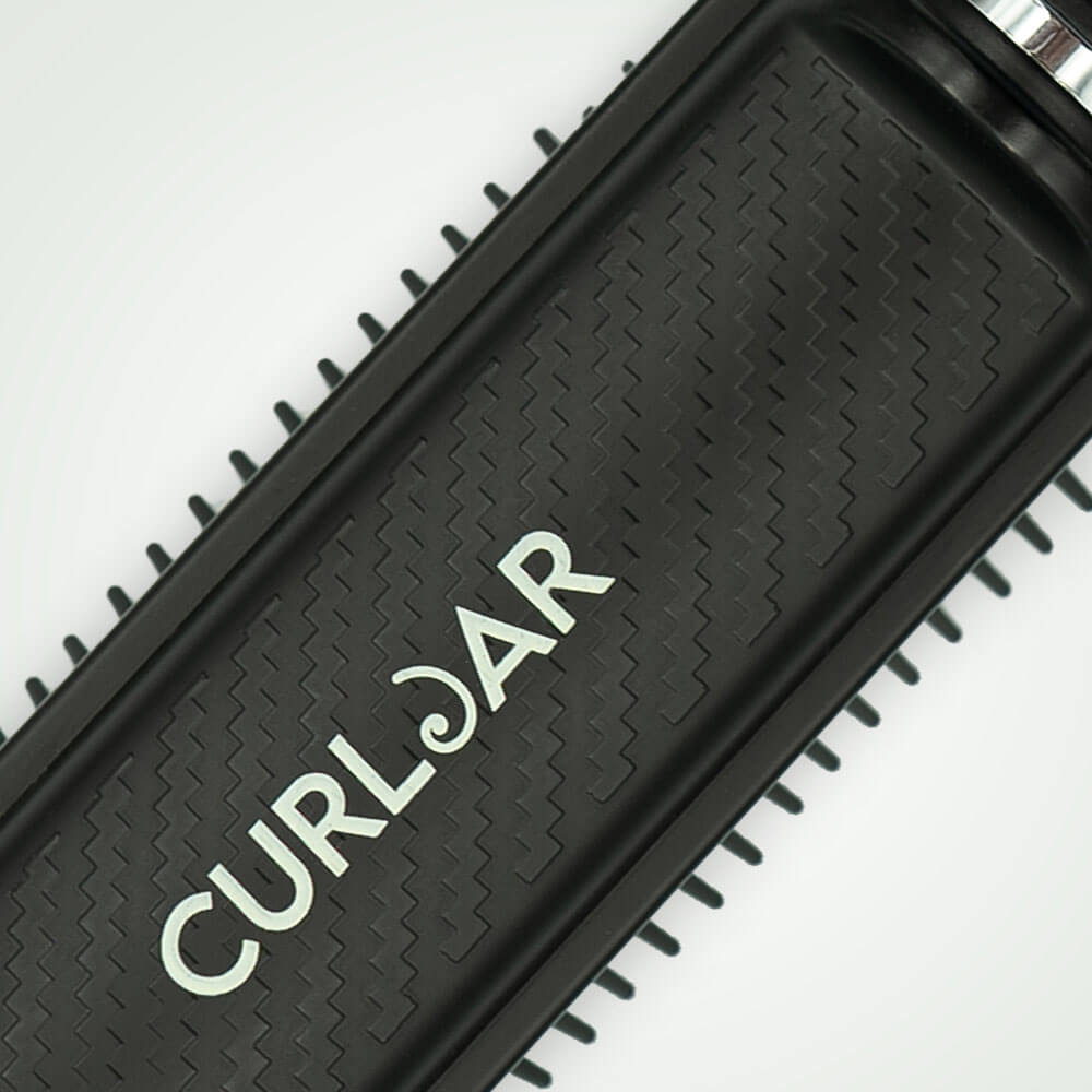Black comb with 'Curlbar' branding on a white background