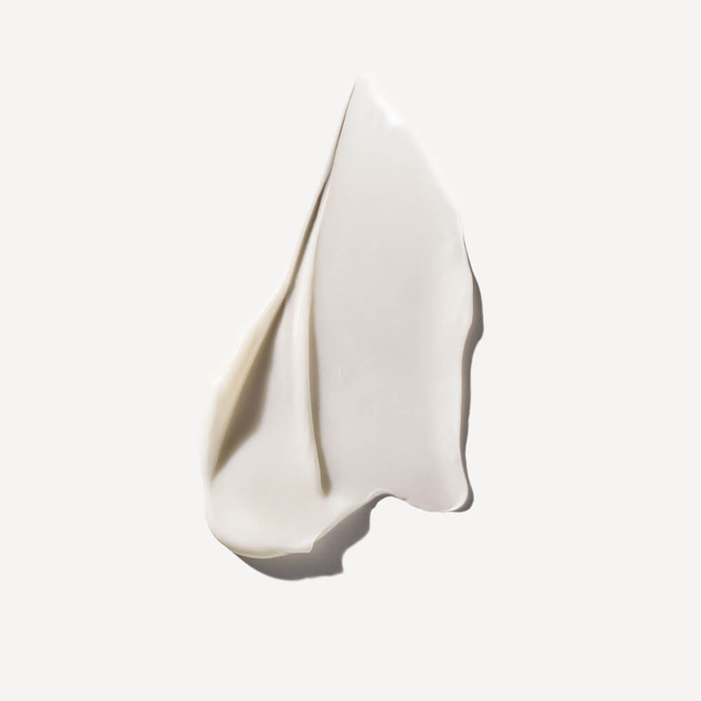 White ceramic sculpture of a face on a light gray background