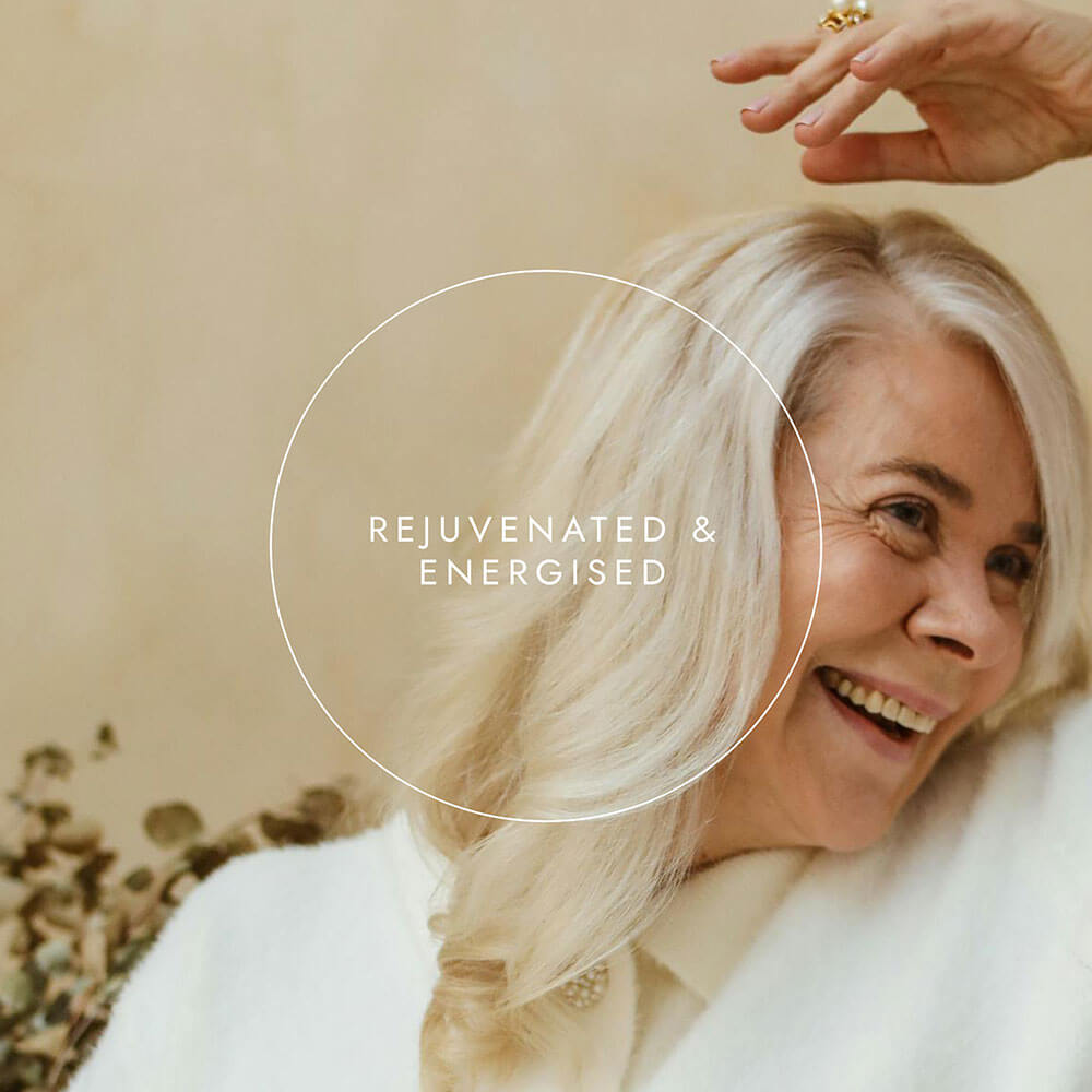 Woman with white hair and a white coat, with text 'Rejuvenated & Energised' on a beige background.