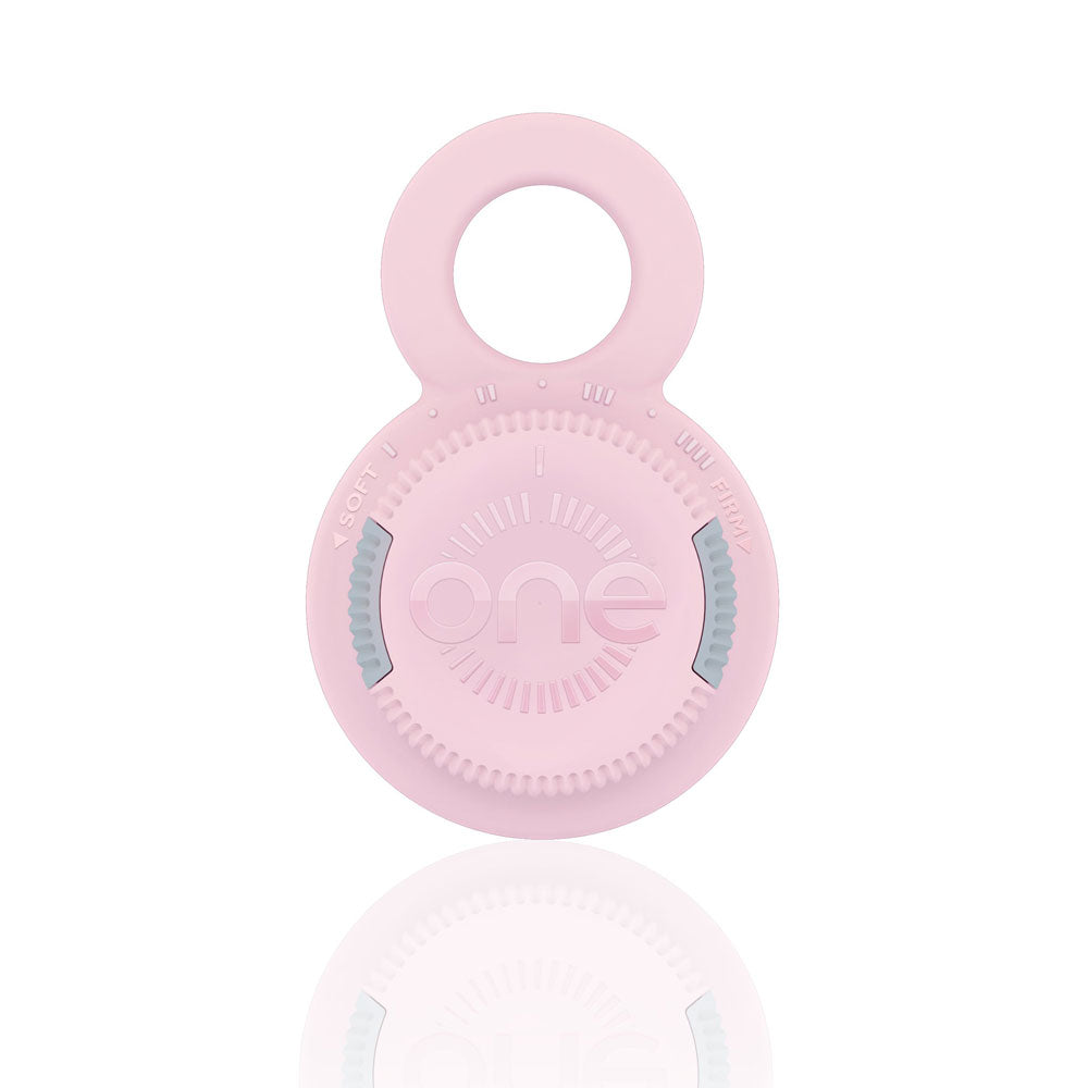 Pink silicone teething ring on a white background