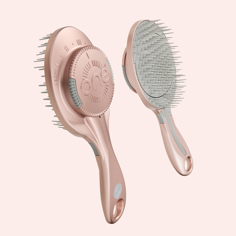Two hairbrushes with different bristle designs on a light pink background