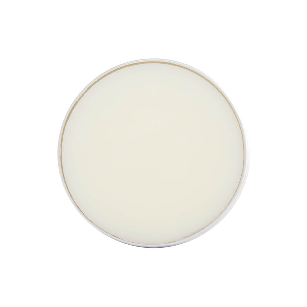 Beard balm in a round white plate with a thin gold rim on a white background