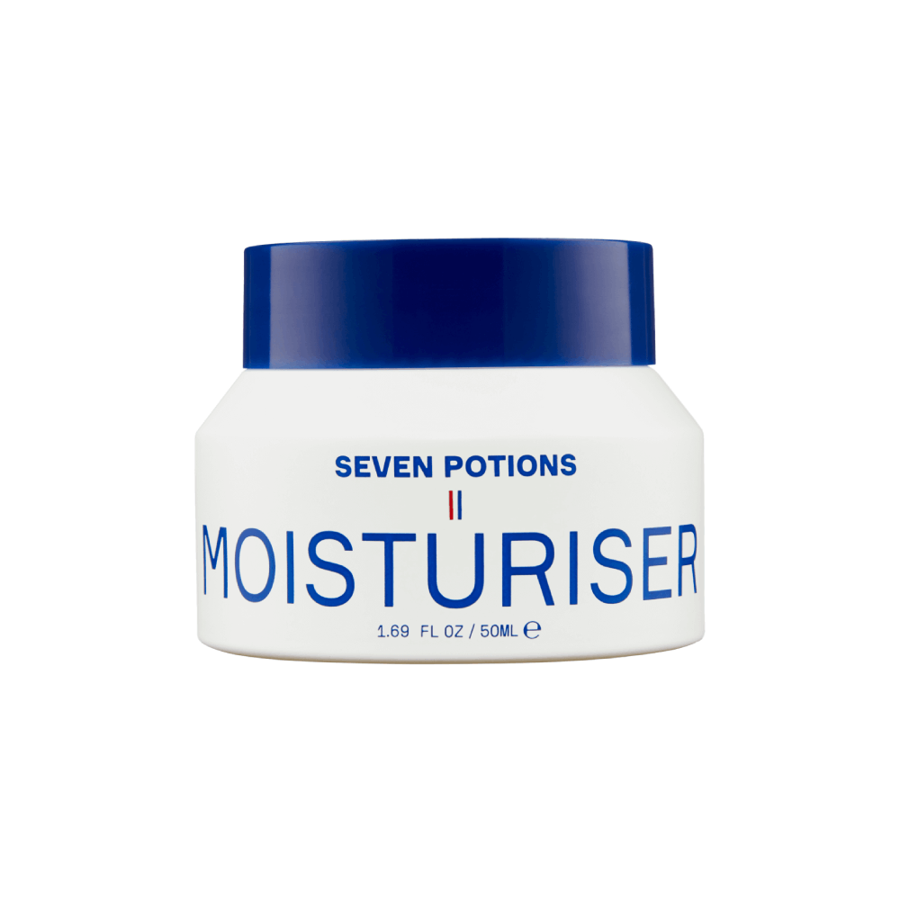 A white jar of Seven Potions Moisturiser with a dark blue lid, featuring blue text and a small French flag detail on the front label, set against a plain white background.