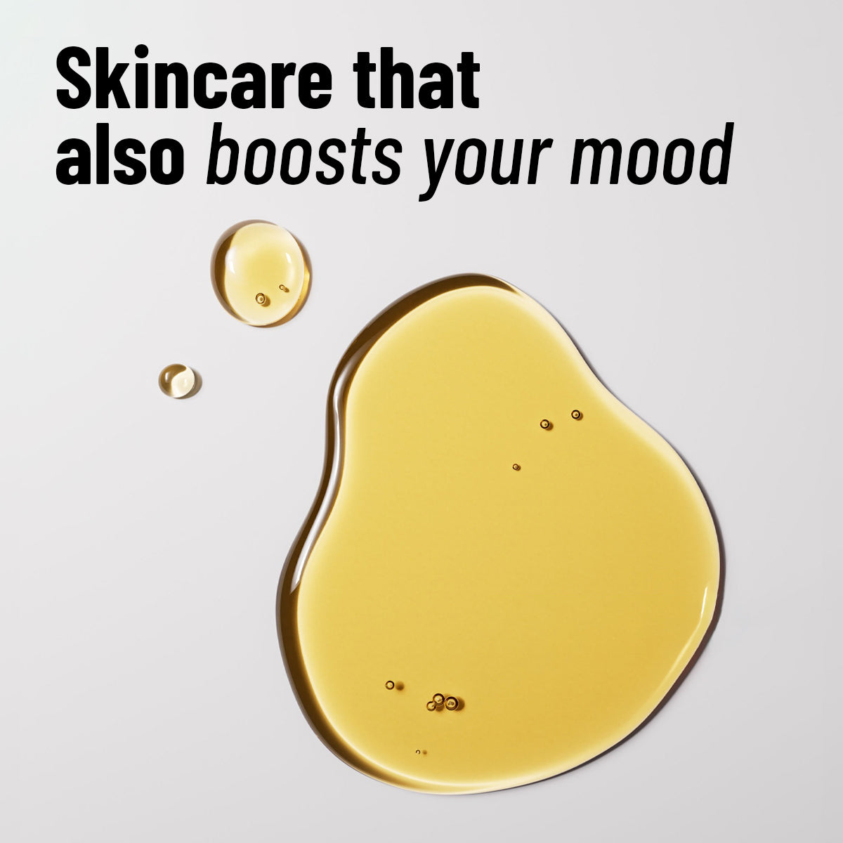 Yellow skincare product with text 'Skincare that also boosts your mood' on a light gray background