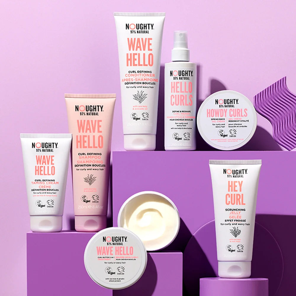 Collection of Noughty hair care products on a purple background