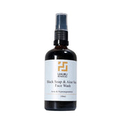 Bottle of Uhuru Botanicals Black Soap & Aloe Vera Face Wash on a white background