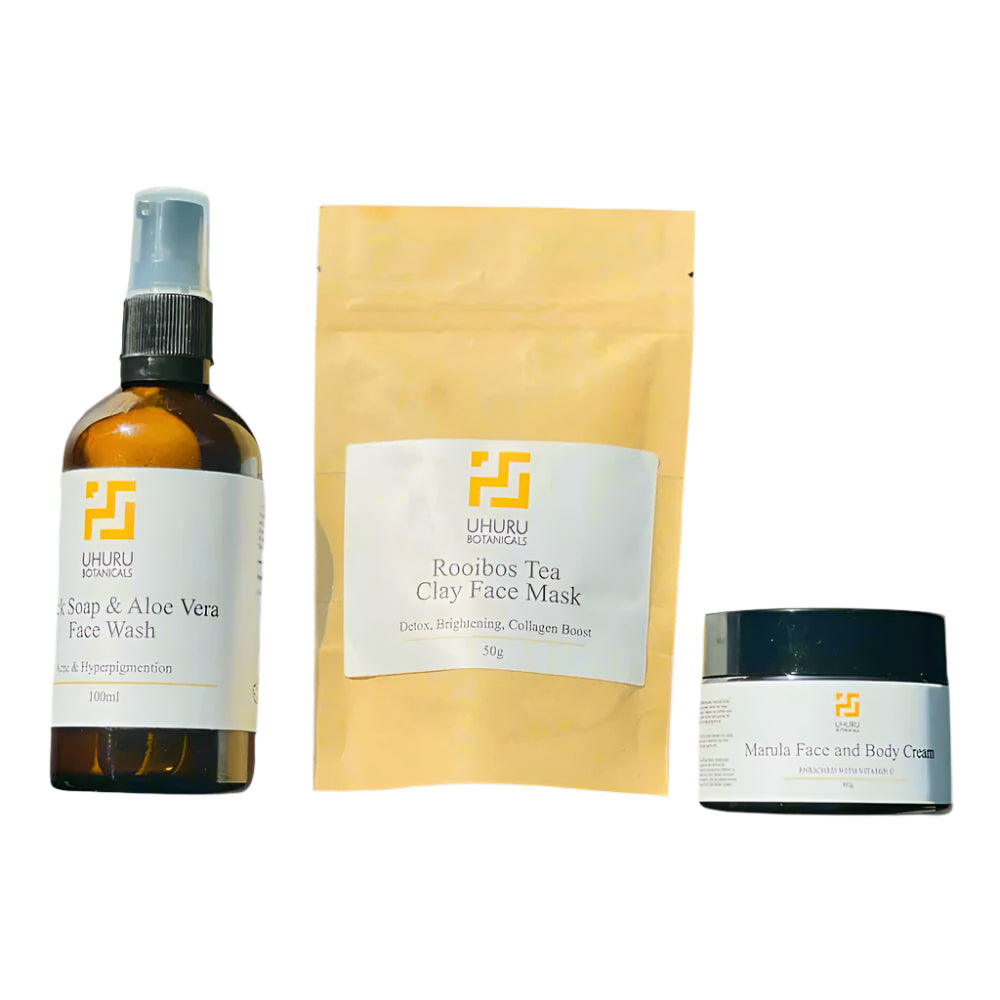 Three skincare products from Uhuru Organics on a gray background