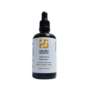 Uhuru Botanicals Chebe Hair & Scalp Serum bottle on a white background