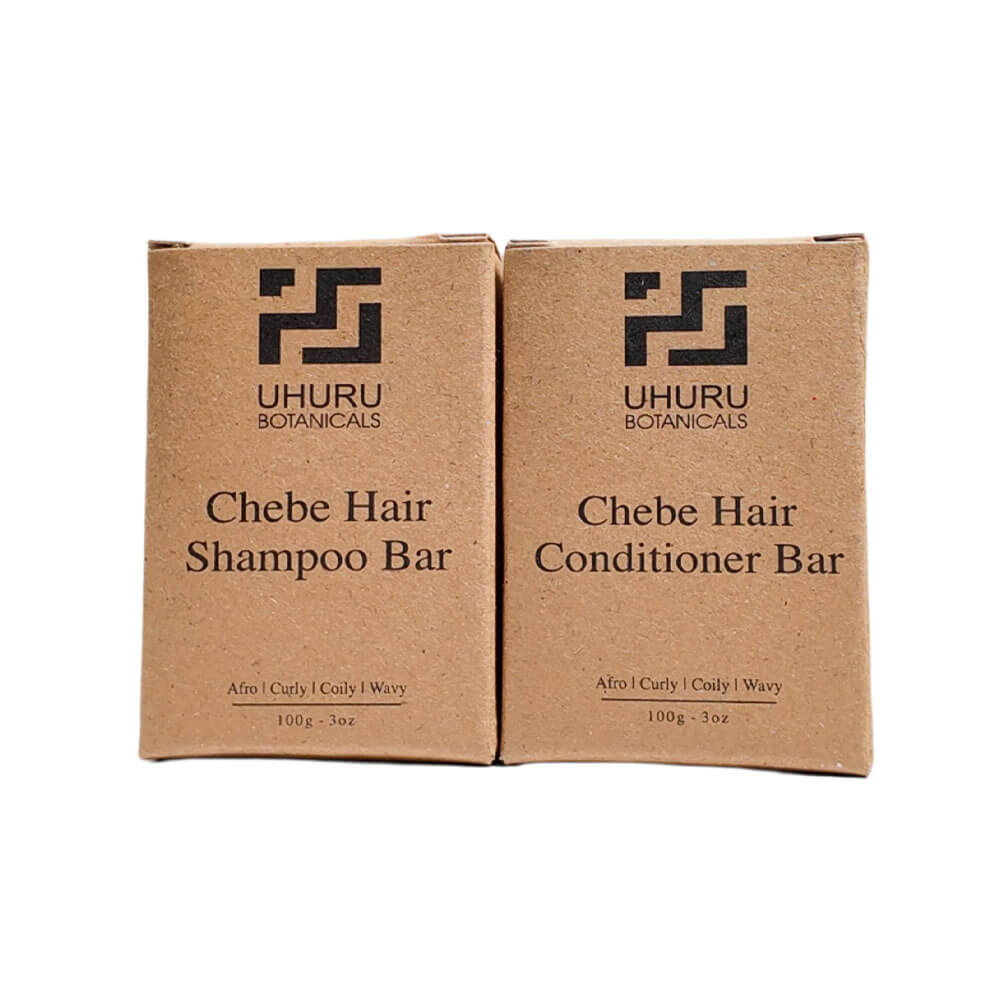 Two cardboard boxes of Uhuru Botanicals Chebe Hair Shampoo and Conditioner Bar on a white background