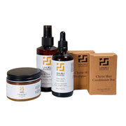 Uhuru Botanicals hair care products including bottles, a jar, and boxes on a white background