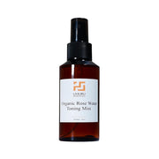 Organic Rose Water Toning Mist bottle with a white label on a white background