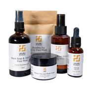 Collection of Uhuru Botanicals skincare products including face wash, cream, and oils on a white background.