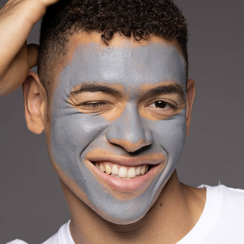 Man with a gray face mask on a gray background