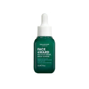 Green skincare serum bottle with dropper on a white background