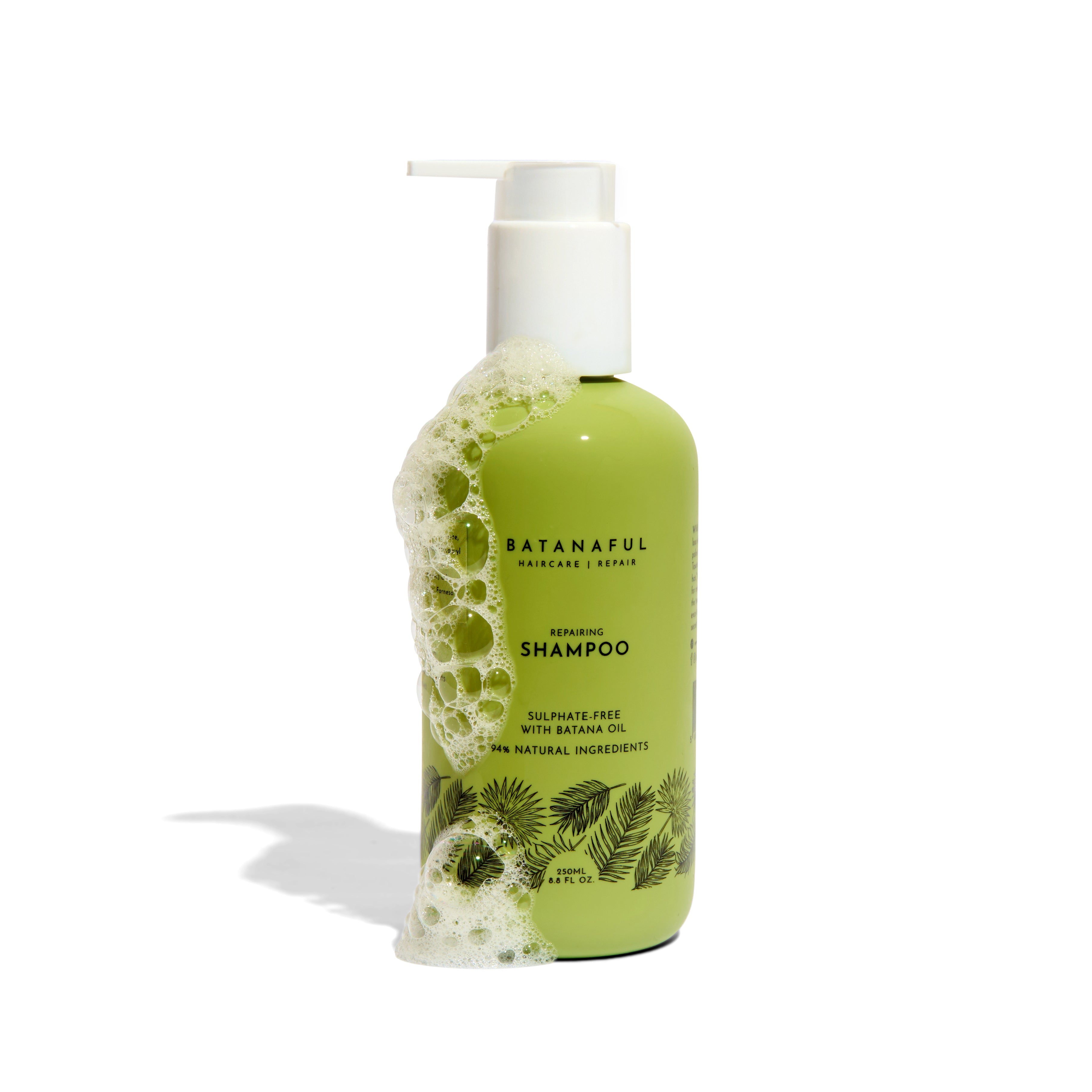 Green shampoo bottle with pump and leaf design on a white background